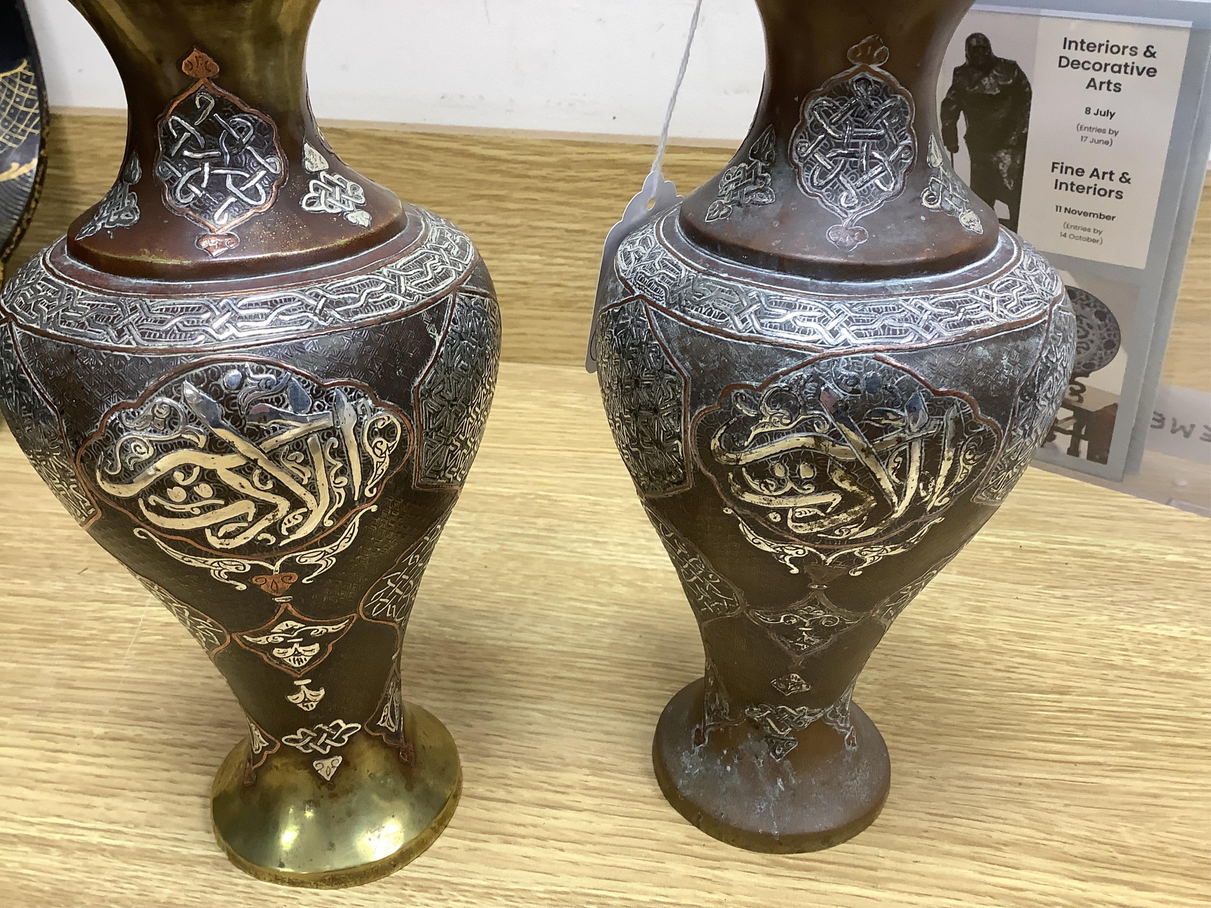 A pair of Cairoware silver and copper inlaid brass vases, 24cm high